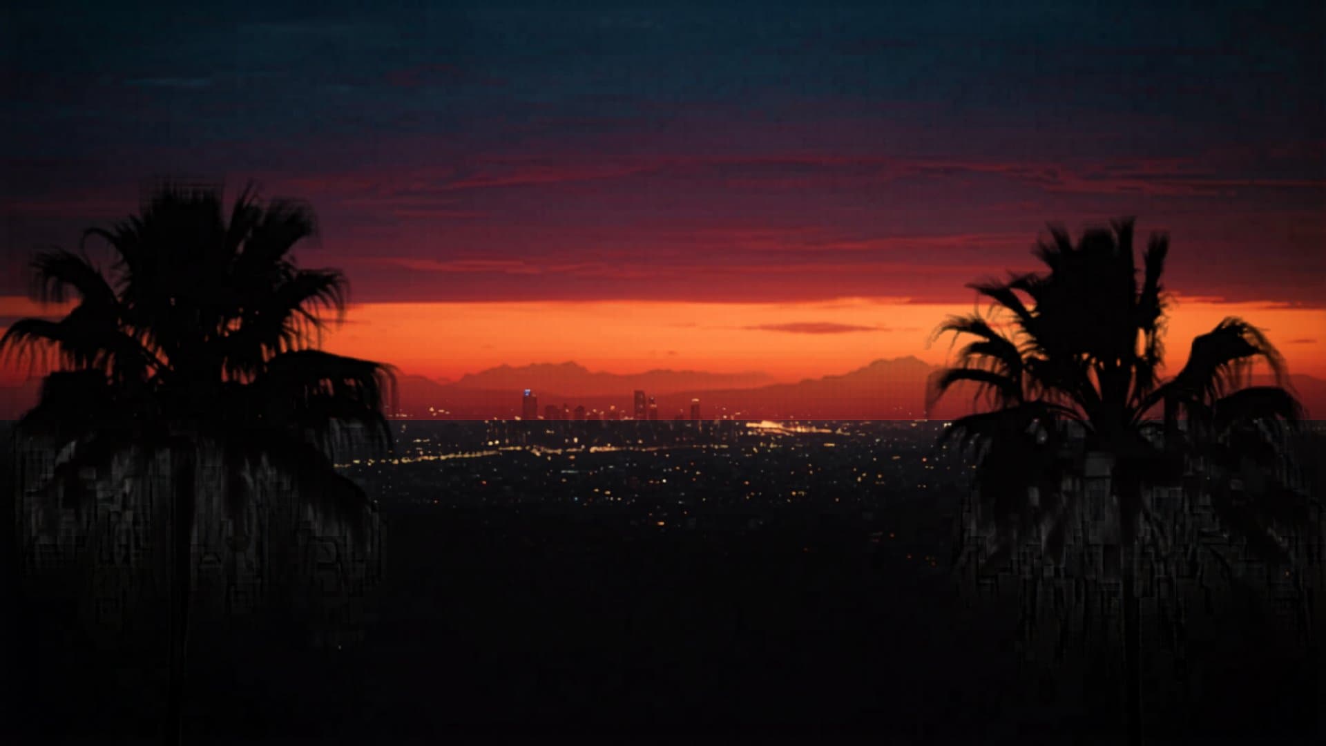 Los Angeles California skyline at sunset with palm trees and mountains